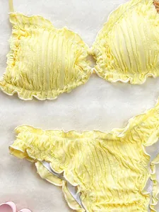 Close-up of yellow ruffle bikini set featuring soft textured fabric and frill edges
