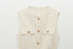 Detaillierte Nahaufnahme einer beigen Tweed-Weste mit eleganten dekorativen Goldknöpfen