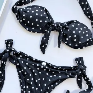Détail d'un ensemble bikini à pois noir et blanc élégant avec des nœuds papillons mignons