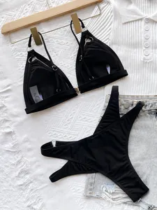 Sexy black two-piece bikini set with hollow out design and metal ring accents for beach