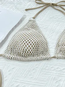 Close-up of a tan triangle bikini top with white crochet mesh overlay details