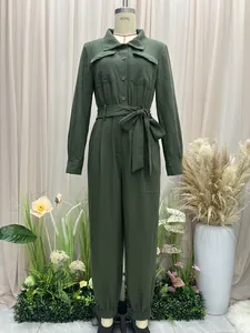 Full view of a green long-sleeve jumpsuit with a waist tie and lapel on a mannequin.