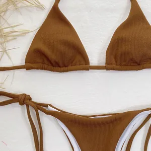 Detail of brown ribbed two-piece triangle bikini set with white lining and ties