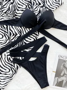Detailed view of a black two-piece bikini set featuring crisscross waist straps.