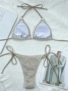 Detailed flat lay of a stylish khaki mesh triangle bikini set on textured white fabric