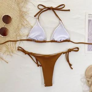 Close-up of solid ochre bikini set with halter top and side-tie thong bottoms.