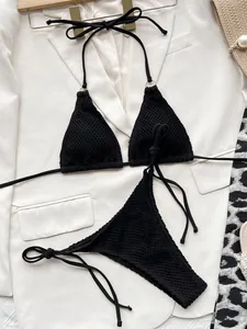 Detail of black textured triangle bikini set with waffle mesh fabric and halter ties