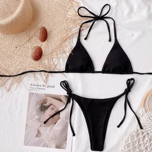 Detailed view of black ribbed bikini set with triangle top and side-tie bikini bottom