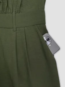 Detailed view of functional side pocket on olive green high-waisted casual jumpsuit