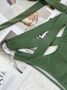 Detailed macro view of an olive green wrap-style bikini showing high-quality fabric and stitching