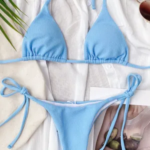 Detail of light blue ribbed bikini set with halter top and tie-side bottoms in summer scene