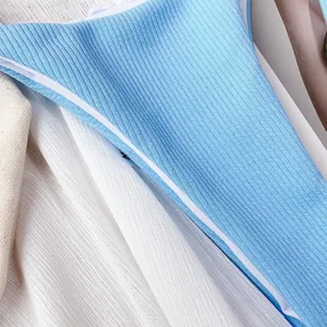 Close-up of sky blue ribbed fabric texture on a two-piece bikini swimsuit set.