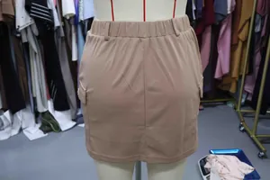 Close-up of khaki knit cargo mini skirt with elastic waist and side pockets on mannequin