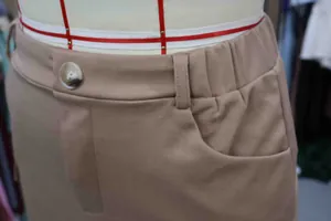 Detail view of khaki knit cargo skirt featuring elastic waistband and large side pocket