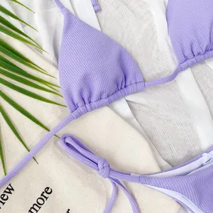 Detail of purple ribbed bikini set with triangle top and side-tie bottoms