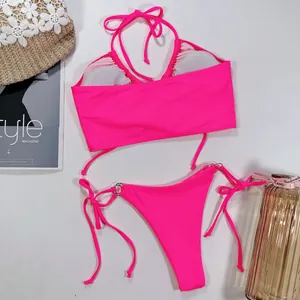 Détail d'un ensemble bikini deux pièces rose néon éclatant avec bas à nouer sur les côtés.
