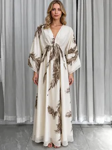 Detail view of bohemian maxi dress with brown feather print and deep V-neck