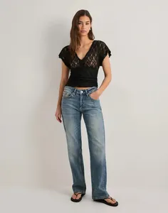 Full body view of a model in Y2K black floral lace sheer mesh short sleeve top