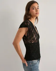 Side view of elegant Y2K black floral lace short sleeve sheer mesh top for women