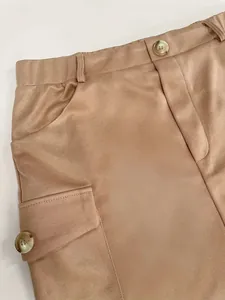 Close-up detail of khaki knitted cargo skirt featuring buttoned pocket and twill texture