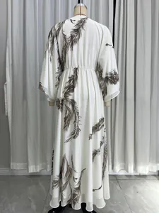 Back view of bohemian maxi dress with brown feather print displayed on a mannequin