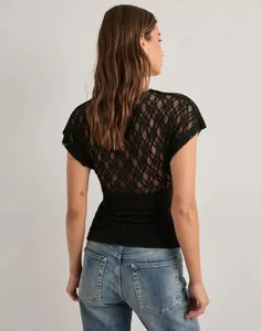 Back view of a black floral lace short sleeve top with transparent mesh details