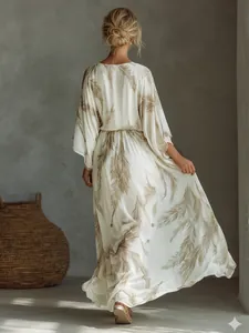Back view of white bohemian maxi dress with brown feather print and batwing sleeves.