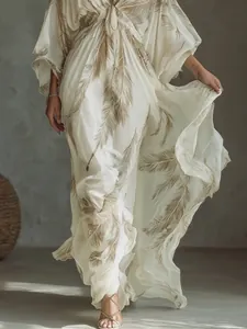 Detailed macro shot of a bohemian feather print vacation dress with flowing batwing sleeves