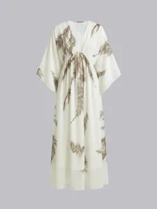 Bohemian white maxi dress with brown feather prints, deep V-neck and batwing sleeves