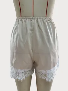 Elegant satin casual shorts featuring delicate white floral lace trim on mannequin form