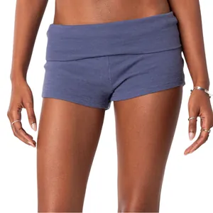 Detailed view of women's blue waffle-knit hot pants with a stylish fold-over low waist.