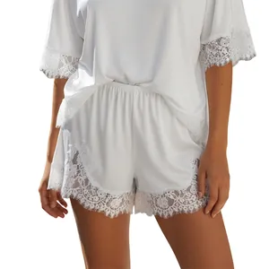 Detailed view of white lounge set with delicate eyelash lace trim on sleeves and shorts