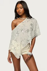 Élégante cape à une épaule transparente avec motifs floraux en paillettes argentées
