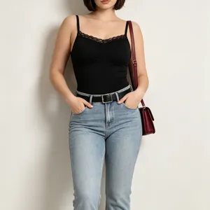 Close-up of a black high-quality lace bodysuit paired with stylish denim jeans