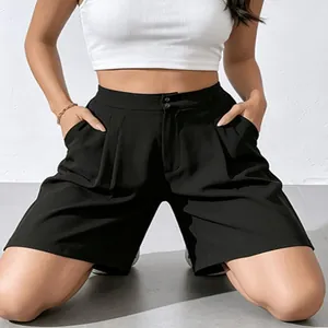 Detailed view of women black high-waisted wide-leg suit shorts with elegant double buttons