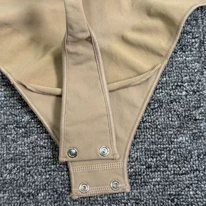 Close-up of the snap-button crotch closure on a beige bodysuit shapewear