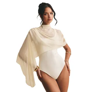 Detail of elegant sleeveless white bodysuit with an asymmetrical mesh shawl overlay.