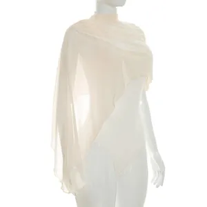 Detail view of the sheer mesh texture and asymmetrical shawl design on this cream bodysuit