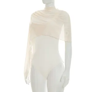 Detailed view of an asymmetric off-white mesh shawl layered over a sleeveless bodysuit