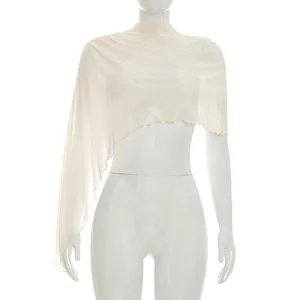 Macro detail view of an asymmetrical sheer cream mesh shawl shown on a white mannequin.