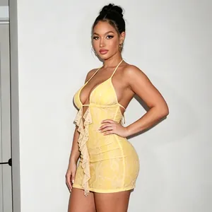 Close-up of yellow lace mini dress with ruffled front and sexy backless design