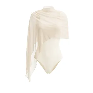 Detailed view of cream sleeveless bodysuit with asymmetrical mesh shawl overlay.