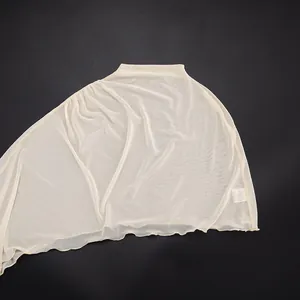 Detail view of the elegant ivory sheer mesh asymmetric shawl with fine fabric texture