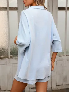 Detailed back view of a light blue striped shirt and shorts two-piece set for women.