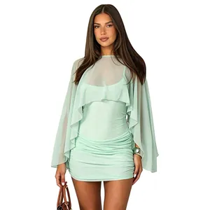 Detailed view of mint green mesh mini dress with matching sheer long sleeve shawl