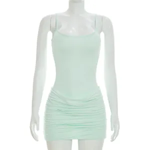 Detail shot of a mint green ruched mini dress with thin spaghetti straps on a mannequin.