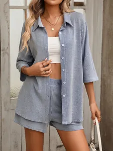 Detailed view of women's blue striped shirt and high waist shorts leisure two-piece set