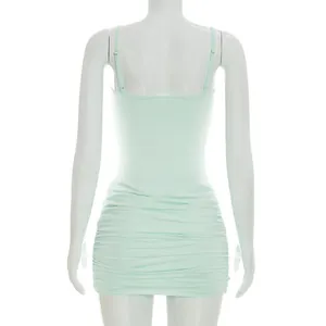 Detail view of a summer mint green ruched cami mini dress on a white mannequin