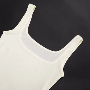 Detail view of the square neckline and breathable mesh fabric of this cream bodysuit