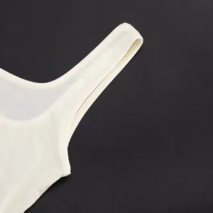 Close-up detail showing quality stitching on a white asymmetric mesh sleeveless bodysuit